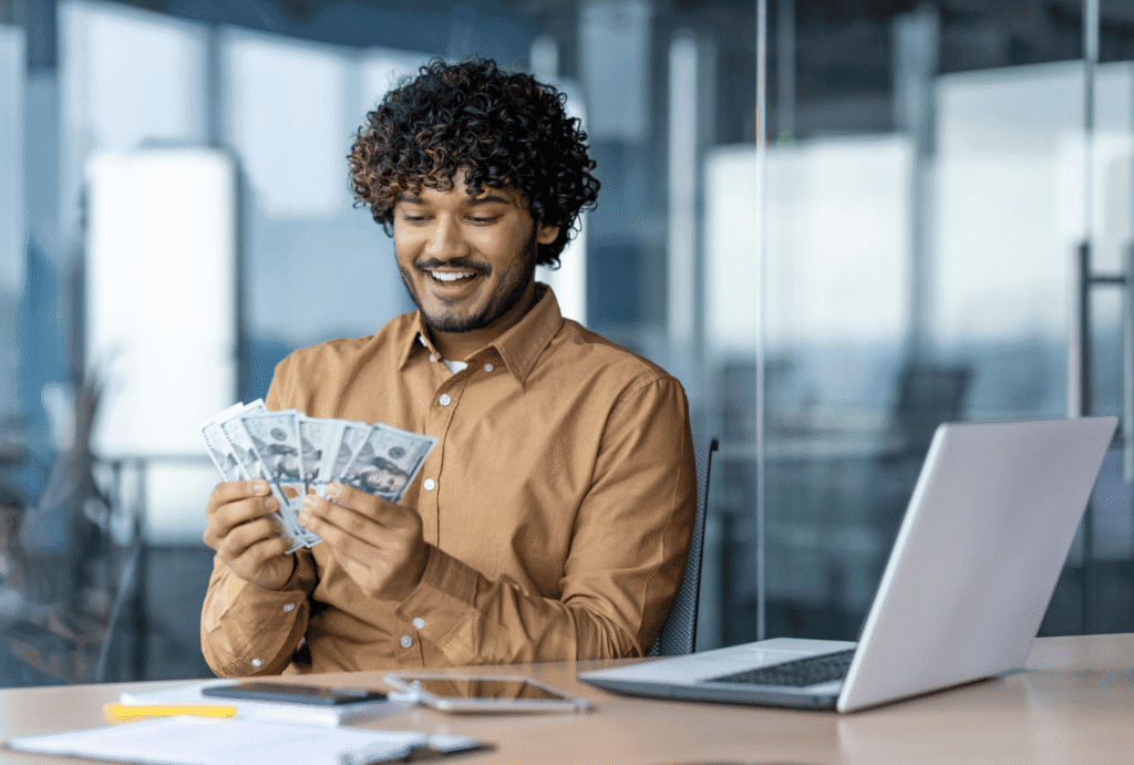 Man looking at his final paycheck in cash